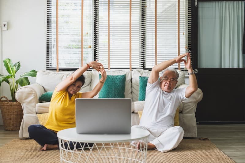 Old man and woman do some yoga exercise