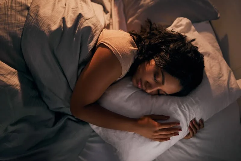 High-angle-shot-of-a-beautiful-young-woman-sleeping-in-her-bed-at-home-1